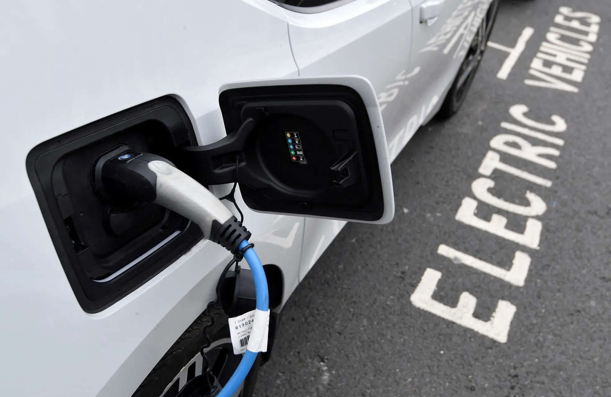 An electric car is charged at a roadside EV charge point London